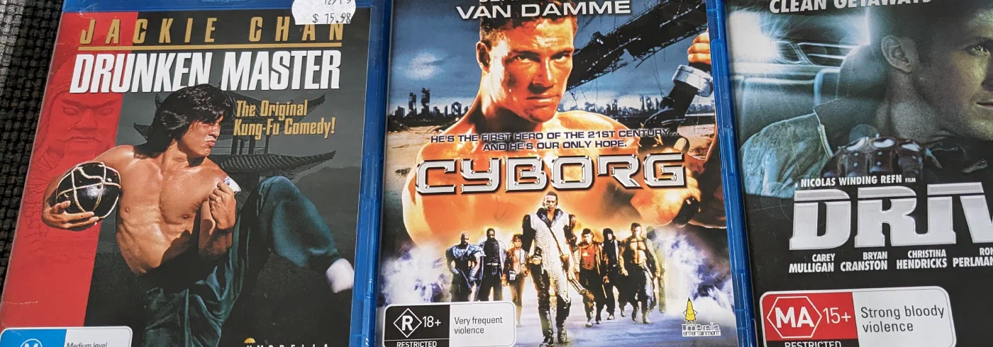 A row of Blu-ray movie cases stacked on a couch
