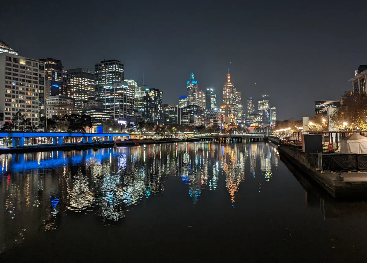 Melbourne's lit skyline reflected in the Yarra River at night