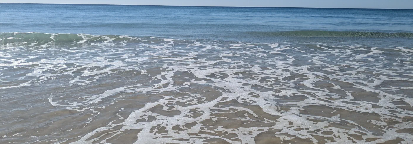 Close-up of foaming waves rolling onto a beach